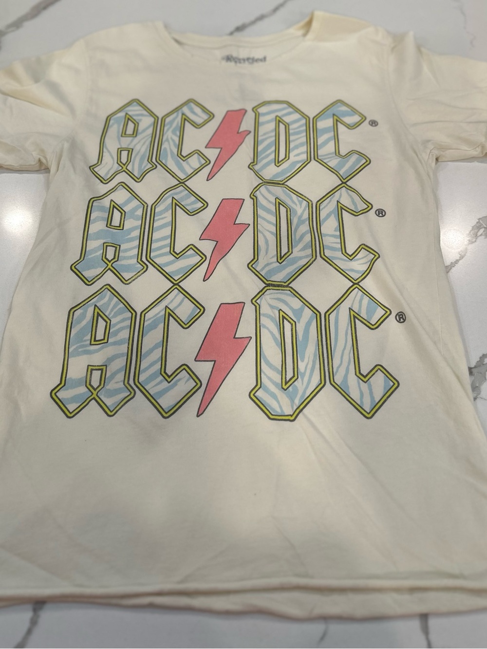 AC/DC Cream Tee with Pink Lightning and Blue Graphic
